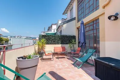 a patio with chairs and tables on a balcony at MY CASA - LAMARTINE - Studio w terrace and AC Very central in Nice