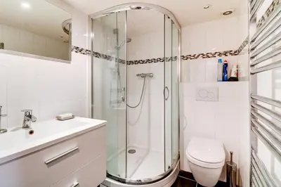 a bathroom with a shower and a toilet and a sink at Spacieux Duplex - Zone Piétonne in Nice