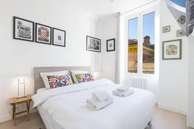 a bedroom with a white bed with towels on it at MY CASA - MOULIN - Stunning 1 bedroom Apt on the Port in Nice