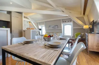 a kitchen and dining room with a wooden table and chairs at MY CASA - ETATS UNIS 896 - Magic view rooftop terrace in Nice