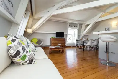 a living room with a white couch and a table at MY CASA - ETATS UNIS 896 - Magic view rooftop terrace in Nice