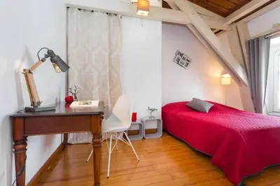 a bedroom with a desk and a bed with a red bedspread at MY CASA - ETATS UNIS 896 - Magic view rooftop terrace in Nice