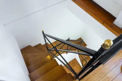 a staircase with a metal rail and wooden floors at MY CASA - ETATS UNIS 896 - Magic view rooftop terrace in Nice
