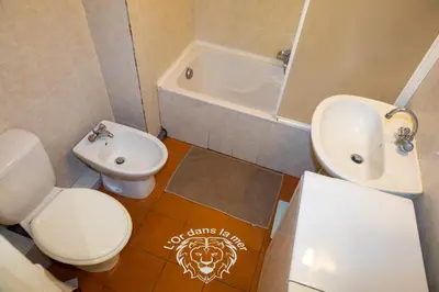 a bathroom with a toilet and a sink and a tub at l'Or dans la Mer 3 in Nice