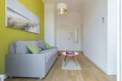 a living room with a couch and a table at MASSENA 33 - Cosy Studio City Center in Nice