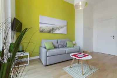 a living room with a couch and a table at MASSENA 33 - Cosy Studio City Center in Nice