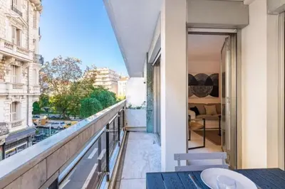a balcony with a table and a view of a city at MY CASA - ROSSINI - Central and cosy with AC in Nice