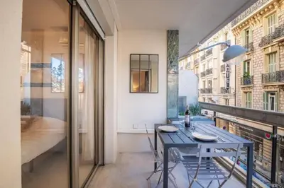 a dining room with a table and a balcony at MY CASA - ROSSINI - Central and cosy with AC in Nice
