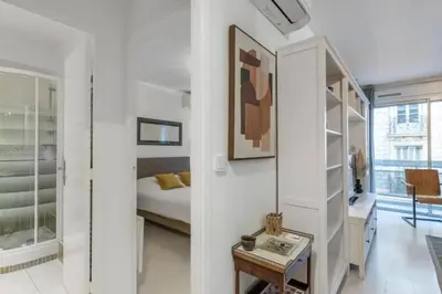 a white bedroom with a bed and a desk and a table at MY CASA - ROSSINI - Central and cosy with AC in Nice