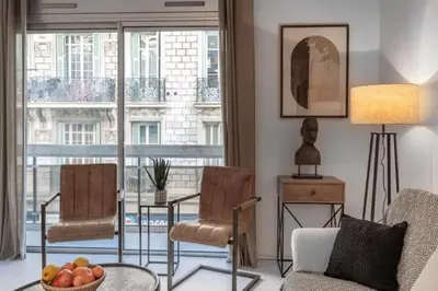 a living room with a couch and chairs and a large window at MY CASA - ROSSINI - Central and cosy with AC in Nice