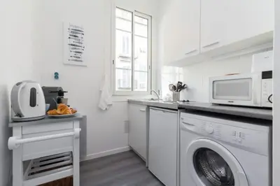 a white kitchen with a washing machine and a microwave at MY CASA - ETATS UNIS 893 - Studio on Seafront in Old Town in Nice