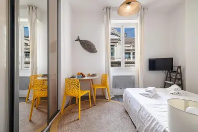 a small room with a bed and a table and chairs at MY CASA - ETATS UNIS 893 - Studio on Seafront in Old Town in Nice