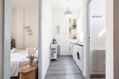 a white room with a bed and a washing machine at MY CASA - ETATS UNIS 893 - Studio on Seafront in Old Town in Nice