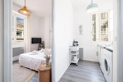 a white room with a bed and a sink at MY CASA - ETATS UNIS 893 - Studio on Seafront in Old Town in Nice