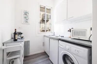 a white kitchen with a washing machine and a microwave at MY CASA - ETATS UNIS 893 - Studio on Seafront in Old Town in Nice