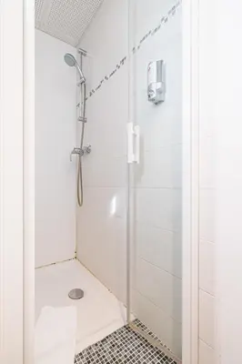 a shower with a glass door in a bathroom at MY CASA - ETATS UNIS 893 - Studio on Seafront in Old Town in Nice