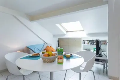 a white table and chairs in a living room at MY CASA - PORT 1 - Spacious and central w AC on the Port in Nice