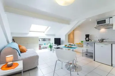 a living room with a couch and a kitchen at MY CASA - PORT 1 - Spacious and central w AC on the Port in Nice