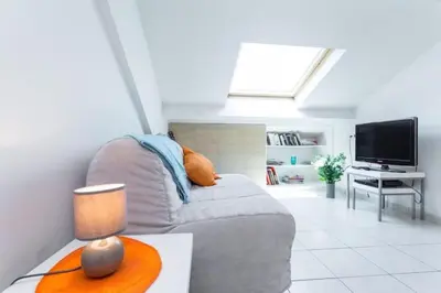 a living room with a couch and a tv at MY CASA - PORT 1 - Spacious and central w AC on the Port in Nice