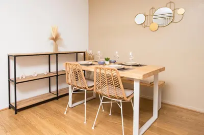 a dining room with a table and two chairs at Appartement rénové - Terrasse - Parking - BM in Nice
