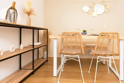 a dining room with a table and two chairs at Appartement rénové - Terrasse - Parking - BM in Nice