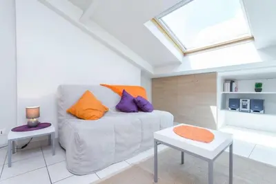 a living room with a couch and a skylight at MY CASA - PORT 2 - Spacious and central w AC on the Port in Nice