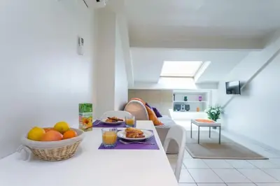 a living room with a table with a bowl of fruit at MY CASA - PORT 2 - Spacious and central w AC on the Port in Nice