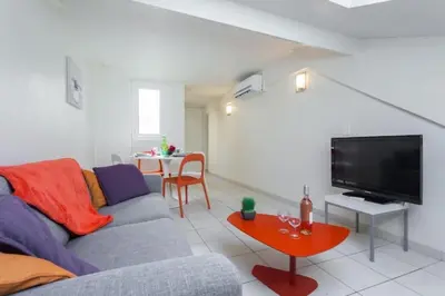a living room with a couch and a flat screen tv at MY CASA - PORT 3 - Spacious and central w AC on the Port in Nice