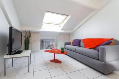 a living room with a couch and a tv at MY CASA - PORT 3 - Spacious and central w AC on the Port in Nice