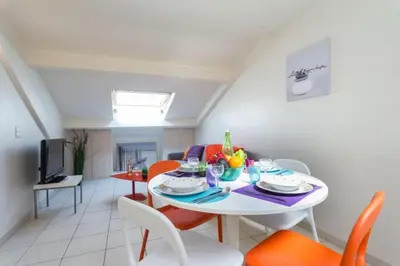 a dining room with a white table and chairs at MY CASA - PORT 3 - Spacious and central w AC on the Port in Nice