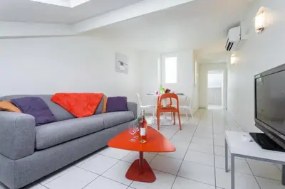 a living room with a couch and a table at MY CASA - PORT 3 - Spacious and central w AC on the Port in Nice