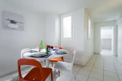 a white dining room with a table and chairs at MY CASA - PORT 3 - Spacious and central w AC on the Port in Nice