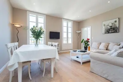 a living room with a white table and a couch at MY CASA - JEAN JAURES - 90m2 w AC 2min to Beach in Nice