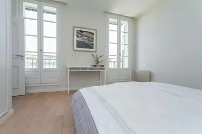 a white bedroom with a bed and a desk at MY CASA - JEAN JAURES - 90m2 w AC 2min to Beach in Nice