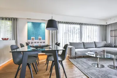 a living room with a dining table and a couch at Sublime Appartement Promenade des Anglais (1) in Nice