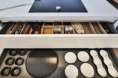 an open drawer with utensils in a kitchen at Sublime Appartement Promenade des Anglais (1) in Nice