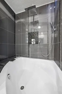 a large white bath tub in a bathroom at Villa vue mer, terrasse et spa in Nice