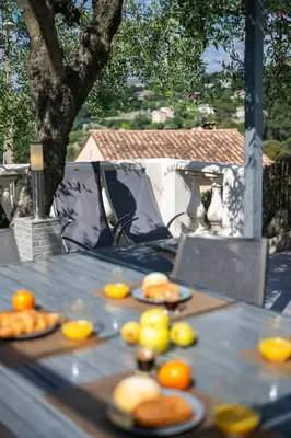 a table with lemons and plates of food on it at Villa vue mer, terrasse et spa in Nice