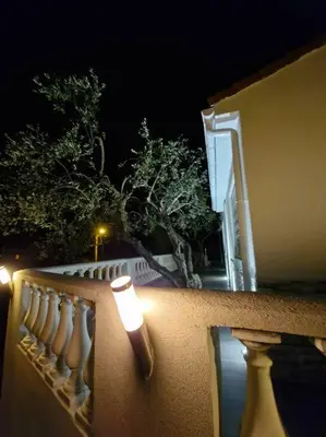 a light on the side of a fence at night at Villa vue mer, terrasse et spa in Nice