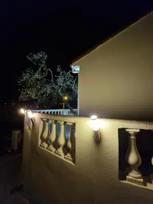 a wall with a bunch of vases on it at night at Villa vue mer, terrasse et spa in Nice