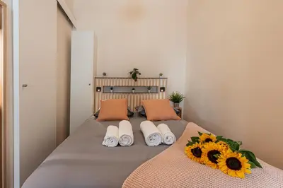 a bedroom with a bed with sunflowers on it at FEEL HOME - COLLET in Nice