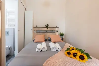 a bedroom with a bed with sunflowers on it at FEEL HOME - COLLET in Nice