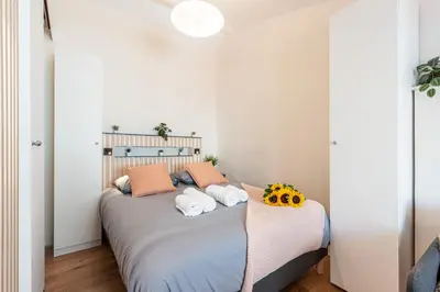 a bedroom with a large bed with two pillows at FEEL HOME - COLLET in Nice