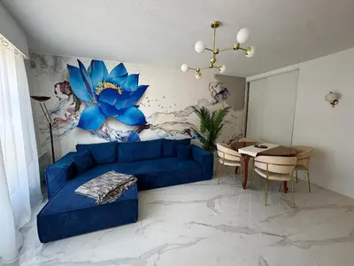 a living room with a blue couch and a table at L'appartement Azur in Nice