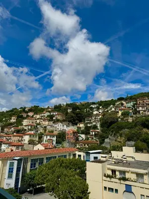 a town on top of a hill with houses at L'appartement Azur in Nice