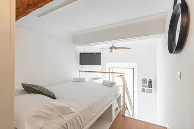 a bedroom with a bed in a white room at Lively district - Duplex Old Town in Nice