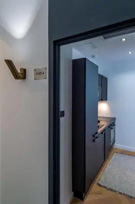 a kitchen with a black door and a kitchen counter at 301a Charming 2 rooms refurbished super center in Nice