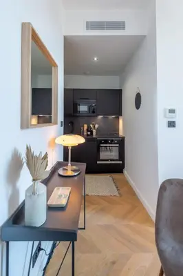 a living room with a table and a kitchen at 301a Charming 2 rooms refurbished super center in Nice