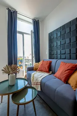 a living room with a blue couch and a table at 301a Charming 2 rooms refurbished super center in Nice