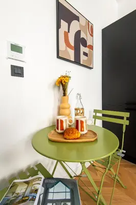 a green table with two mugs and bread on it at 302b Beautiful studio refurbished Downtown / Ac in Nice